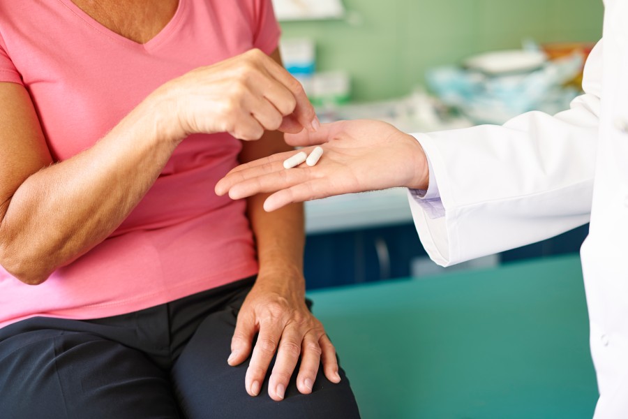 Doctor providing medication as part of PCOD/PCOS treatment to a woman